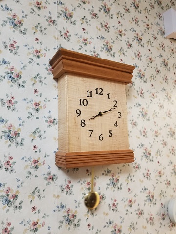 Wall clock made of cherry and kurlly maple by Lenny McHugh